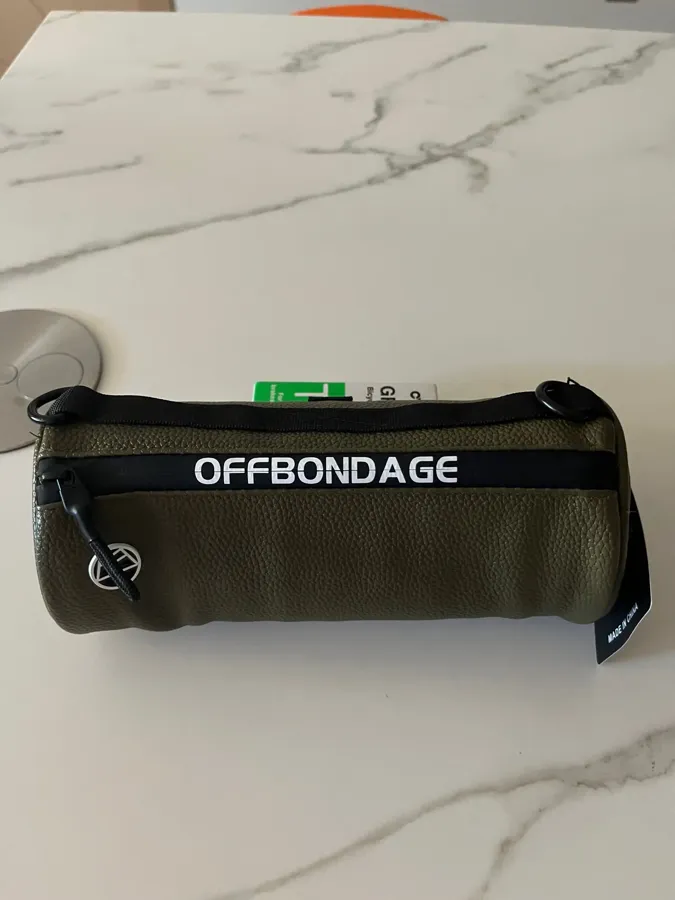 Verified buyer photo of the green barrel handlebar bag with tag