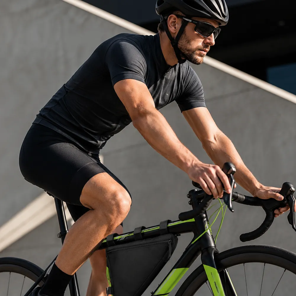 A cyclist riding a road bike fitted with a Ridgeline Trail frame bag